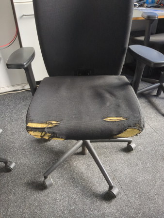Scuffed seat of a swivel chair